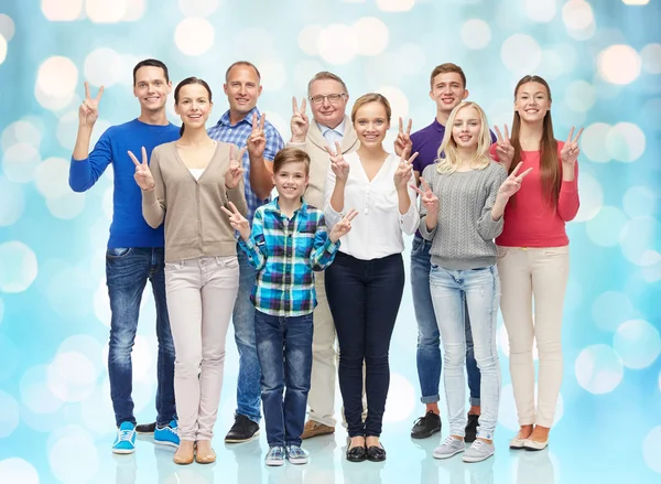 Group of smiling people showing peace hand sign — Stok fotoğraf