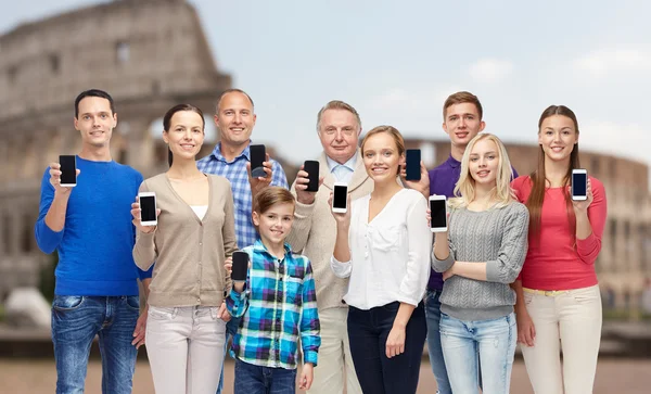 Group of people with smartphones over coliseum — 图库照片