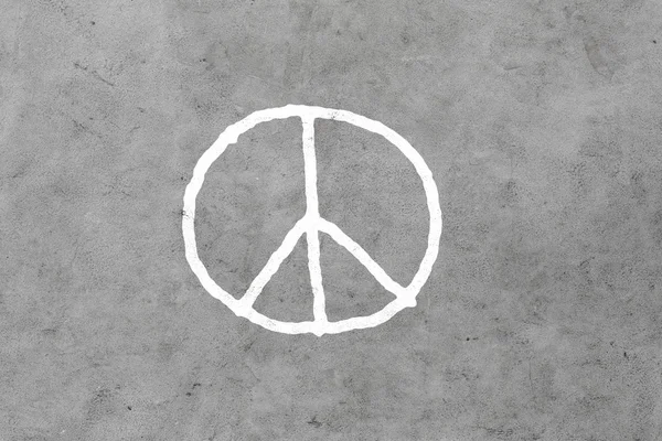 Peace sign drawing on gray concrete wall — Stok fotoğraf