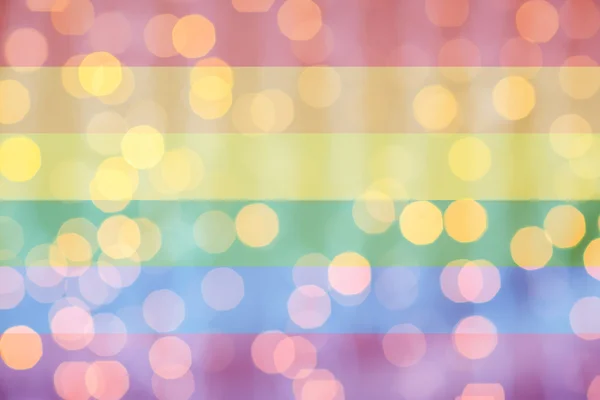 Blurred golden lights over rainbow flag background — Stockfoto