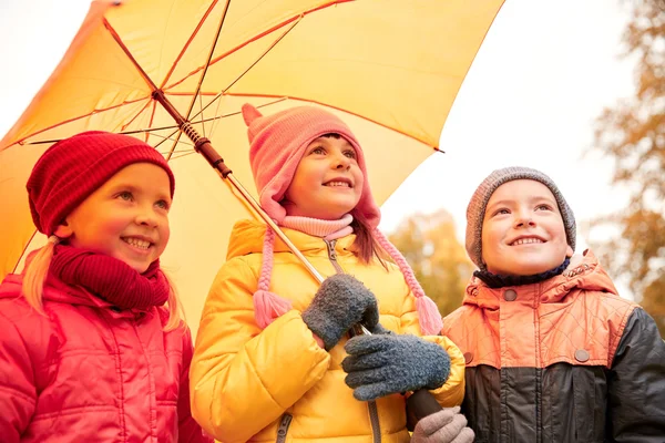 Copii fericiți cu umbrelă în parcul de toamnă — Fotografie, imagine de stoc