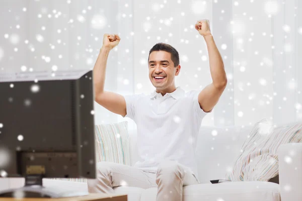 Lächelnder Mann, der zu Hause Sport guckt — Stockfoto