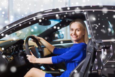 happy woman inside car in auto show or salon clipart