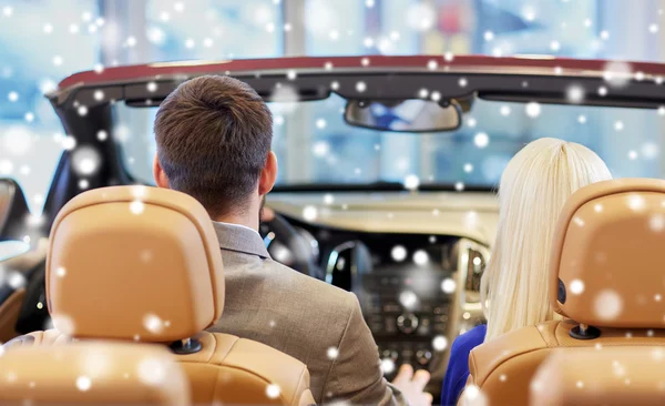 Couple sitting in cabrio car at auto show — Stok fotoğraf