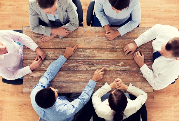 Close up of business team sitting at table — Stock Photo, Image