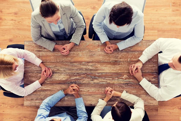 Close up of business team sitting at table — Stock Photo, Image