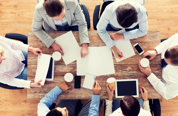 Close up of business team with coffee and papers — Stock Photo, Image