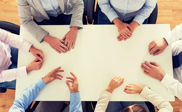 Close up of business team sitting at table — Stock Photo, Image