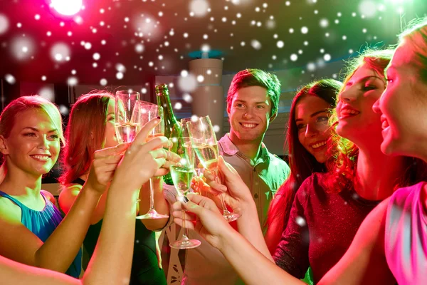 Smiling friends with glasses of champagne in club — Stock Photo, Image