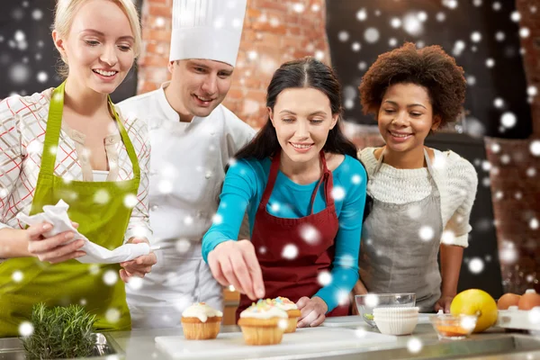 Femmes heureuses et cuisinier cuisinier cuisson dans la cuisine — Photo