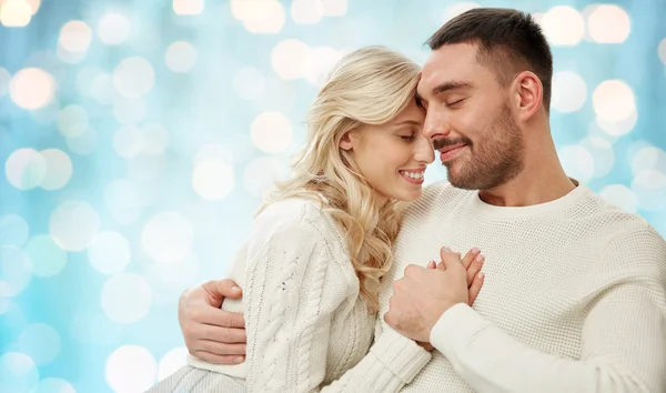 Happy couple over blue holidays lights background — 스톡 사진