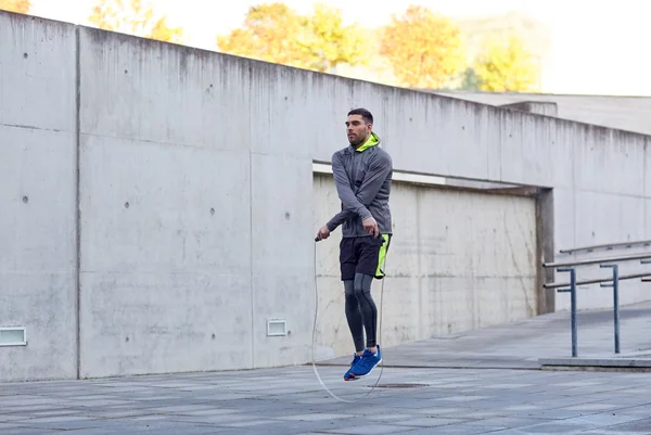 man exercising with jump-rope outdoors