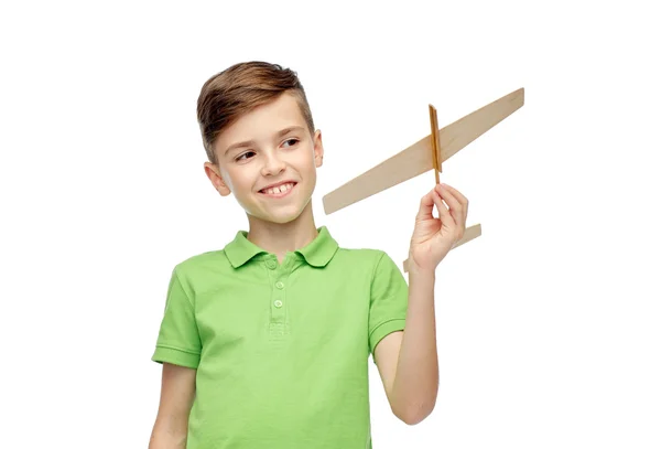 Happy boy in green polo t-shirt with toy airplane — Zdjęcie stockowe
