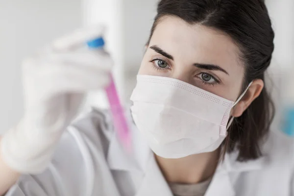 Close up of scientist with tube making test in lab — Stock Photo, Image