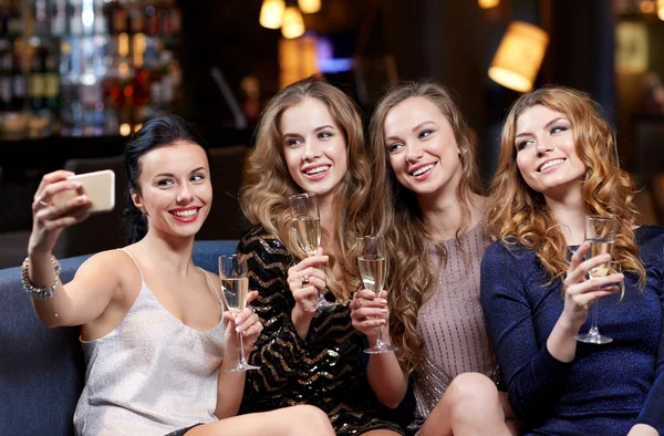 Women with champagne taking selfie at night club — Stock Photo, Image