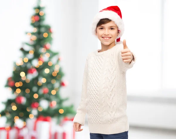 Lachende gelukkige jongen in KERSTMUTS duimen opdagen — Stockfoto