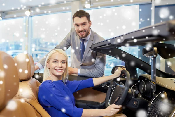 Feliz pareja comprando coche en auto show o salón —  Fotos de Stock