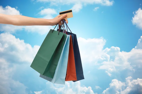 Close up of woman with shopping bags and bank card — Stock Photo, Image