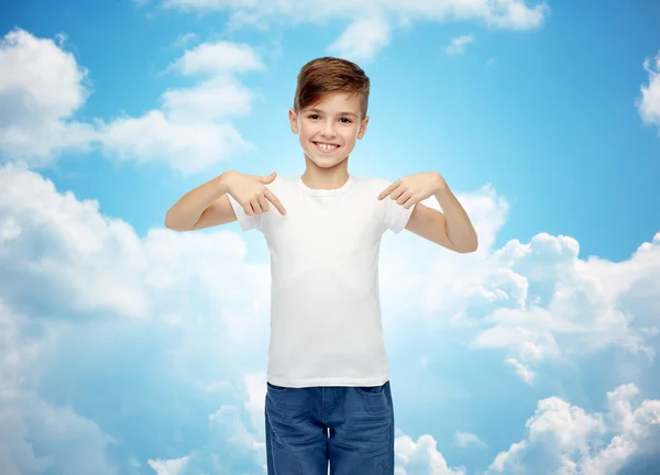 Happy boy pointing finger to his white t-shirt — Stockfoto