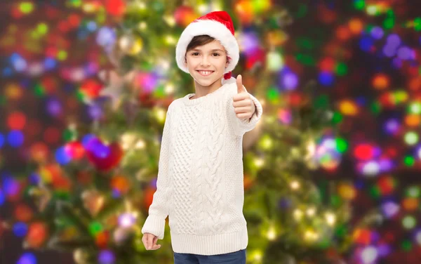 Noel Baba şapkası başparmak göstermek yukarıya içinde gülümseyen mutlu çocuk — Stok fotoğraf