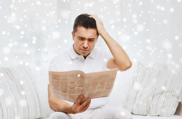 Triste homem lendo jornal em casa — Fotografia de Stock