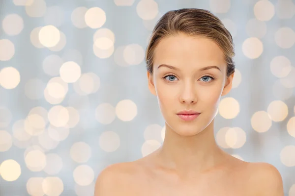 Young woman face with bare shoulders over lights — ストック写真