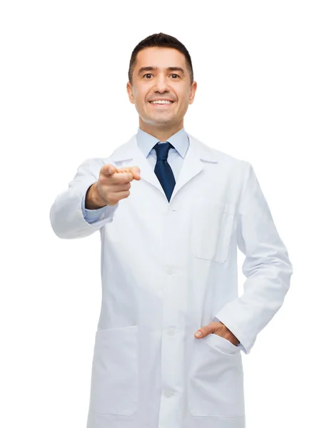 Smiling male doctor in white coat pointing at you — 图库照片