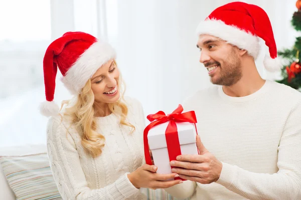 Lyckliga par hemma med jul presentförpackning — Stockfoto