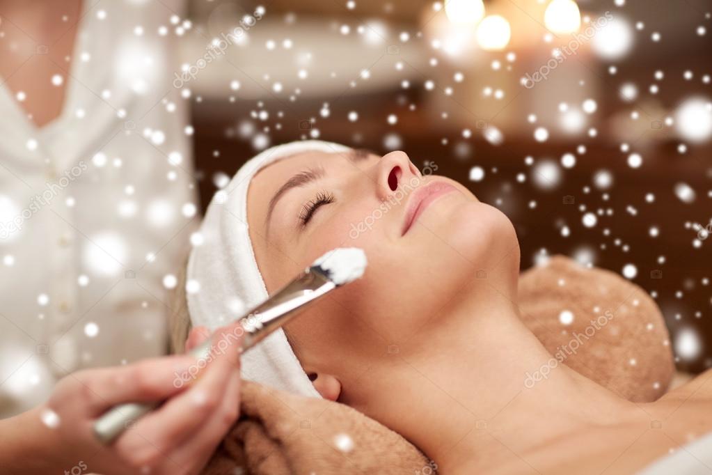 Woman face and beautician applying mask in spa Stock Photo by ©Syda