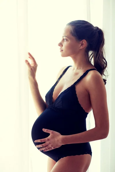 Happy pregnant woman with big bare tummy at home — Stock Photo, Image