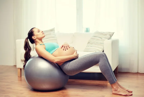 Glückliche Schwangere trainiert zu Hause auf Fitball — Stockfoto