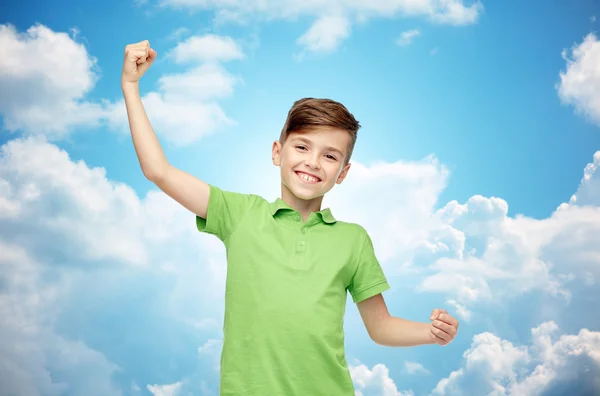 Happy boy in polo t-shirt showing strong fists — Stock Fotó