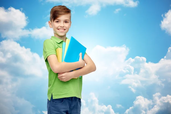 Niño estudiante feliz con carpetas y cuadernos —  Fotos de Stock