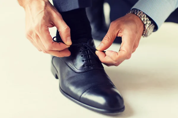 Close up of man leg and hands tying shoe laces — Stock Photo, Image