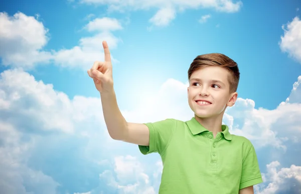 Happy boy in green polo t-shirt pointing finger up — Stock Photo, Image