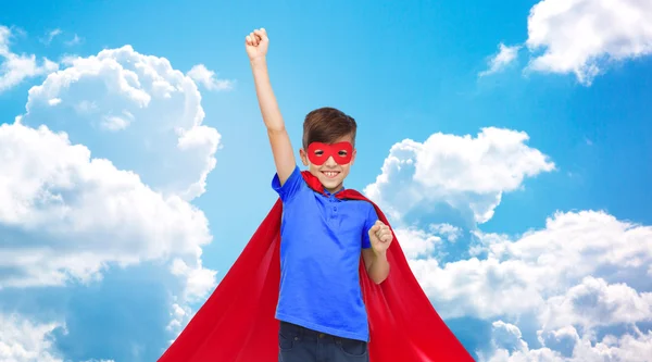 Boy in red super hero cape and mask showing fists — Stock Photo, Image