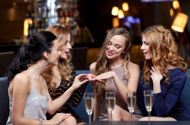 woman showing engagement ring to her friends clipart