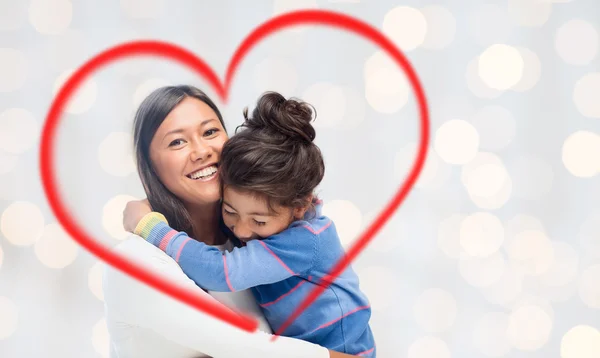 Happy mother and daughter hugging — Stock Photo, Image