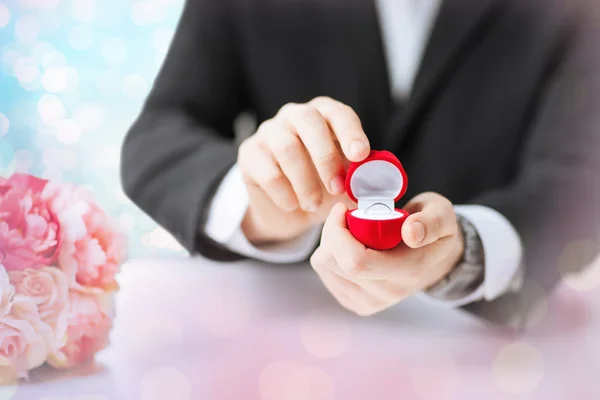 Close up of man with gift box and engagement ring — 스톡 사진