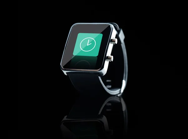 Close up of black smart watch with clock icon — Stock Photo, Image
