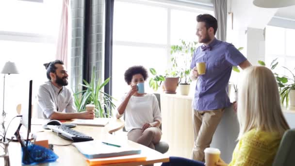 Счастливая творческая команда пьет кофе в офисе — стоковое видео