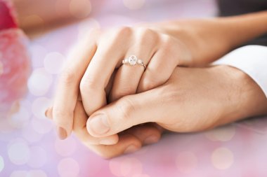 close up of couple hands with engagement ring clipart