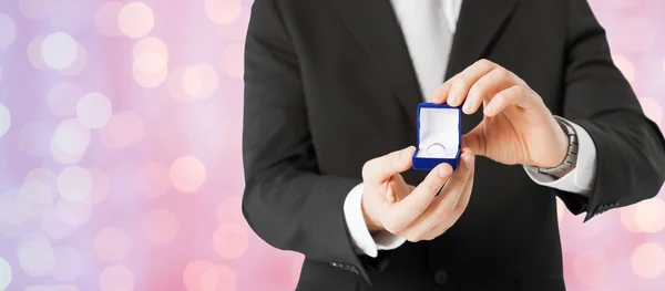 Close up of man with gift box and engagement ring — 스톡 사진