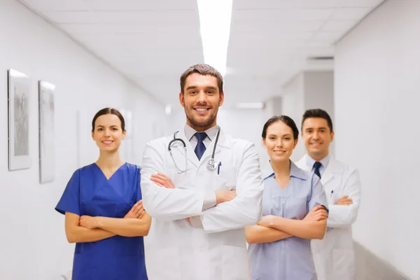 Happy group of medics or doctors at hospital — Stock Photo, Image