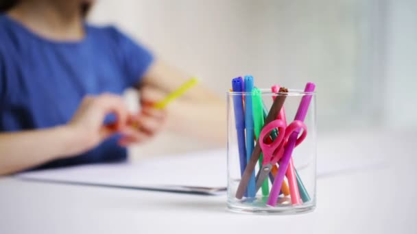 Plumas de fieltro en vidrio y dibujo de niña sobre papel — Vídeo de stock