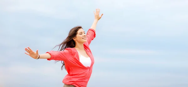 Girl with hands up on the beach — Stock Photo, Image