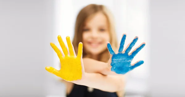 Girl showing painted hands — Stock Photo, Image