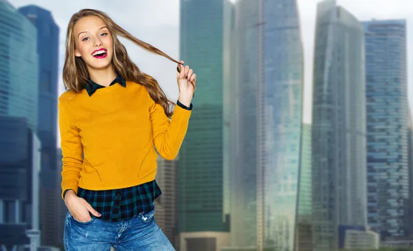 Happy young woman or teen girl over city — Stockfoto