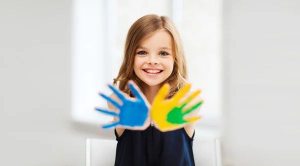 Girl showing painted hands — Stock Photo, Image