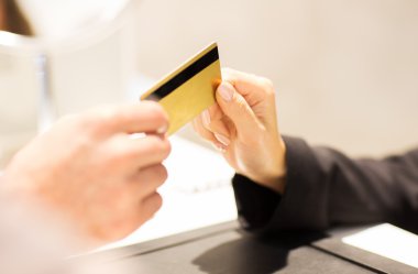 close up of hand giving credit card to seller clipart
